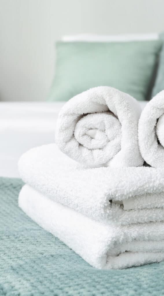 Clean soft towels on bed